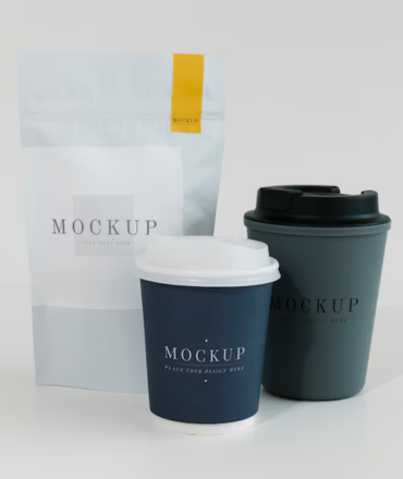 Packaging mockup of two coffee cups and a pouch on a white background.